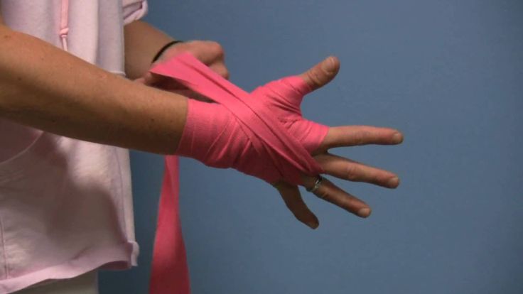 Man wrapping pink hand wraps
