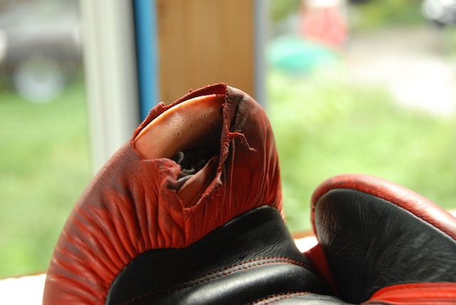 black and red boxing glove ripped at top