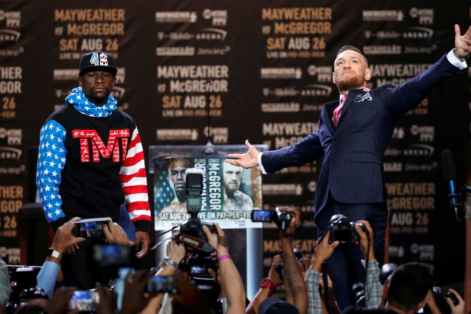 Floyd Mayweather and Conor McGregor posing at a press conference