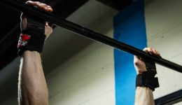 two hands holding a pull up bar
